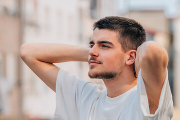 portrait of relaxed bearded caucasian young man outdoors