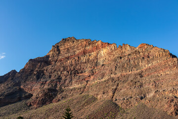 Scenic view on the massive sharp cliffs and mountain Cueva de Cabras in the La Mercia mountain range in Valle Gran Rey, La Gomera, Canary Islands, Spain, Europe. Summit in the Garajonay national park