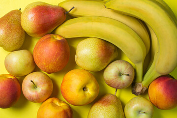 Various fruits on a yellow background. Fruit as a background for your image