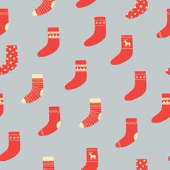 Seamless pattern of red Christmas socks on grey background. Doodle style. Christmas winter background. 
