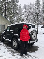 Road trip in the snow with red winter jacket