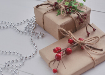Christmas gift boxes and fir tree branch on wooden table. Сhristmas background