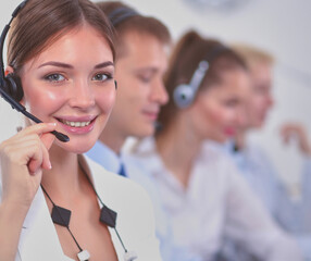 Attractive Smiling positive young businesspeople and colleagues in a call center office