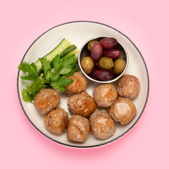 Greek meatballs keftedes on color background.