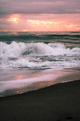 Waves crashing at the beach during sunrise