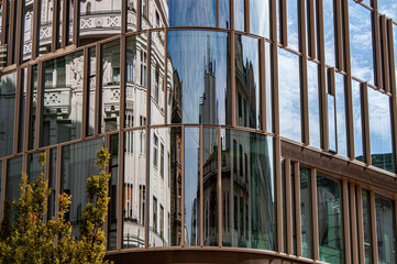 Classical facades reflect from modern glass building on Szervita square in the old town of Budapest, Hungary, Europe.