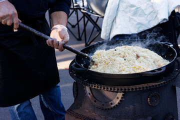 pilaf in a cauldron on the street