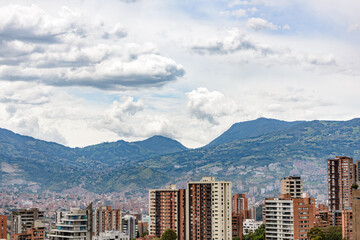 Obraz premium medellin colombia city cityscape with building, iconic architecture and mountains and sky with clouds