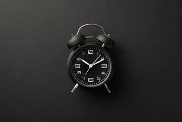 Black friday concept. Top view photo of black alarm clock on isolated black background - obrazy, fototapety, plakaty