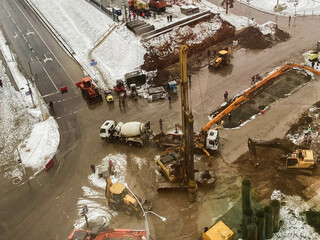 construction of a bridge in the city center. construction equipment, machines for mixing concrete and making asphalt. construction of large concrete structures