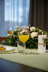 A glass with drinks on a table served with ready meals