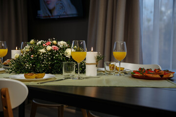 A glass with drinks on a table served with ready meals