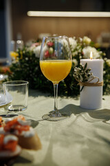 A glass with drinks on a table served with ready meals
