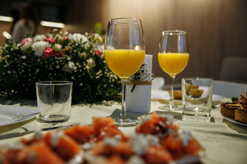 A glass with drinks on a table served with ready meals