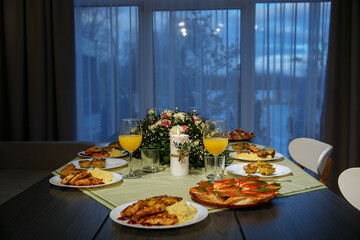 A glass with drinks on a table served with ready meals