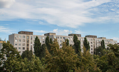 Fototapeta na wymiar Concrete block of flats and cloudy sky in the Gazdagrét neighborhood of Budapest, Hungary, Europe. Residential area consisting of prefabricated buildings in the western part of the 11th district.