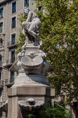 An exterior view of the historical Diana Fountain stands in the central section of Barcelona's Gran Via in Catalonia, Spain, Europe. Tall marble statue of the Roman goddess Diana the huntress.