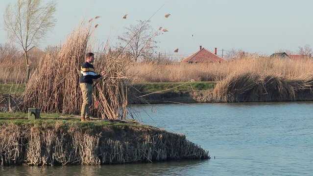 Angler fishing on a peninsula of a lake