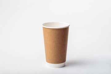 Empty paper cup for coffee made from biodegradable brown paper on a white background. Isolated for mock up