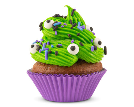 Cupcake. Cupcake on Halloween. Dessert on Halloween party. Chocolate muffin decorated with colored sprinkles, green frosting and Icing. Close-up macro high quality, resolution photo. Isolated on white