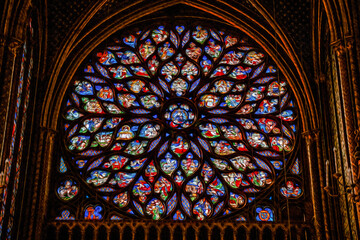 Detail of rose window with colorful stained glass at the Sainte-Chapelle Church in Paris. The charming capital of France. Oil paint filter.