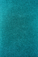 Background with sparkles. Backdrop with glitter. Shiny textured surface. Vertical image. Dark cyan
