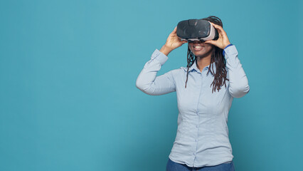 Portrait of woman using vr glasses on camera, working with virtual reality headset and playing with 3d interactive simulation goggles. Feeling happy and excited about wireless tech gadget.