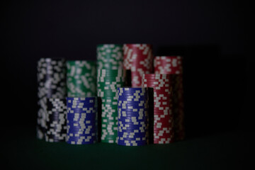 The concept of gambling in casino. Casino interior, playing cards and chips. Dark background and space for text.