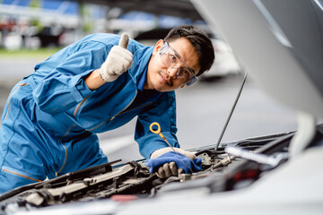 portrait of view Automotive mechanic repairman thumbs up looking confident, positive thinking, very...
