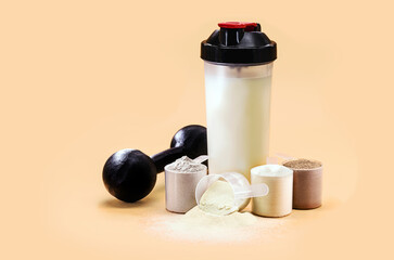 whey or casein shake, whey smoothie with protein chocolate bar, weight training dumbbell on the...