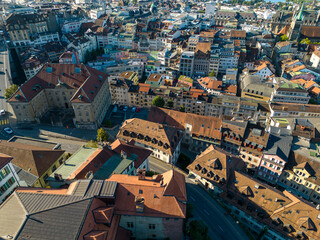 Fototapeta na wymiar Lausanne, Switzerland, August 22nd 2022. Drone aerial view of the city centre at sunrise