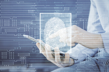 Double exposure of man's hands holding and using a digital device and fingerprint hologram drawing....