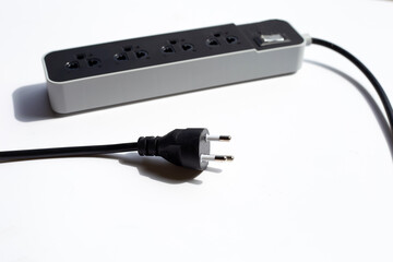 Electrical power strip and plug on white background.