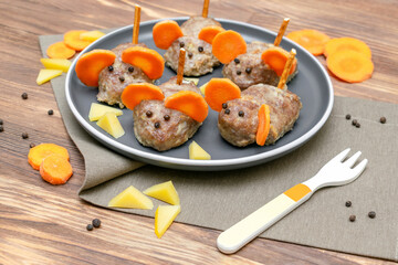 Small meatball mouse, meatloaf mice with ears of carrot, cheese on plate, creative and fun food snack idea for kids party. Menu for spooky Halloween dessert treats, edible cute rat selective focus