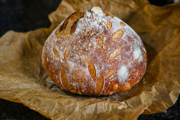Close-up of a beautiful loaf of fresh-baked sourdough on parchment