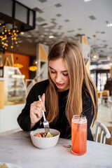 young girl eating in a cafe