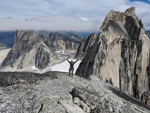 Climber stands on summit between Rock Spires