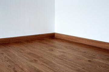 Laminate wood floor with blank white wall