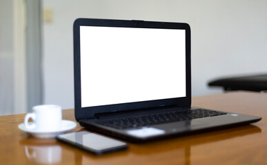 Close up view computer mockup white background on table. Cell phone blank screen. Laptop with blank screen at work desk.