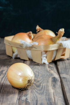 Onions on a wooden background. Ingredients for onion soup and salads.Farm vegetables. Diet. Vitamins.