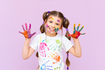 A little girl painted with multicolored paints will playfully have to create on a pink isolated background. Development of children's creativity for schoolchildren. © Юлия Дьякова