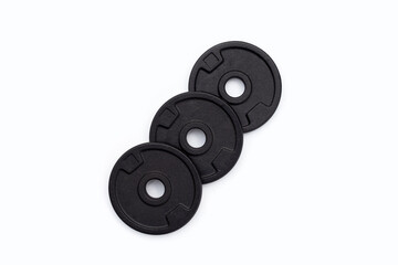 Black weight plates on white background. Gym equipment