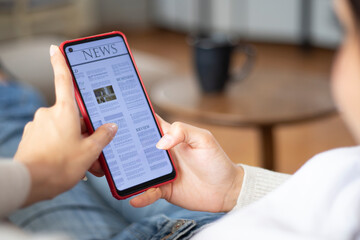 woman reading news on smart phone