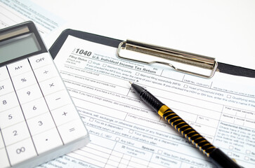 Tax Return 1040, calculator and pen. Tax concept