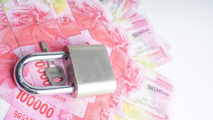 Safe money. Indonesia Money Rupiah and padlocks isolated on a white background. Selective Focus