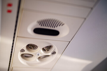 Photo of an airplane air conditioning vent with turn to open feature