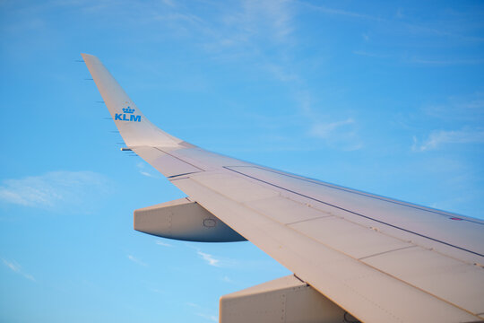 Photo of a KLM airplane wing on a blue sky