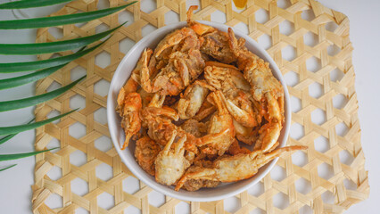 fried crabs in bowl, street seafood beside the beach or path. selective focus
