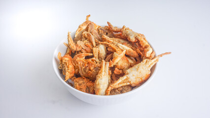 Small crab fried in white bowl. isolated on white background.Selective Focus