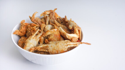 fried crabs in white bowl, street seafood beside the beach or path. selective focus